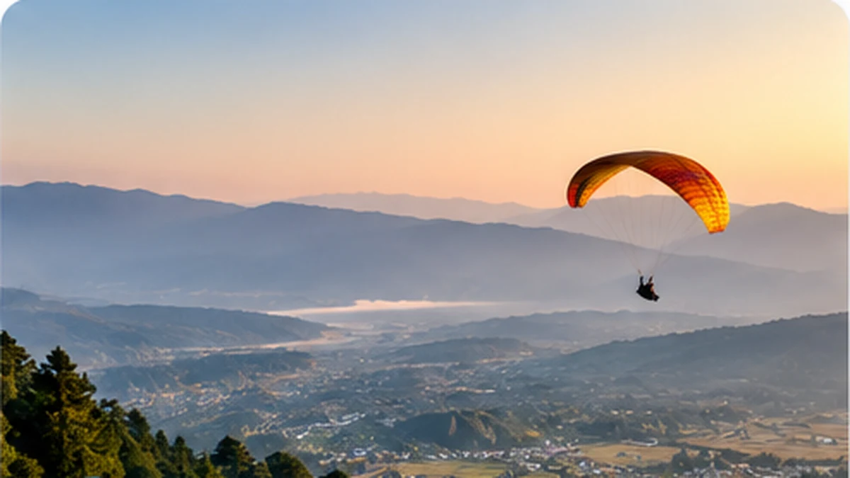 Sunset panorama over the Kangra Valley with a paraglider in the sky